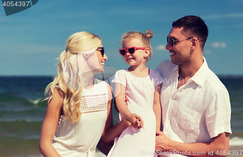 Image of happy family in sunglasses on summer beach