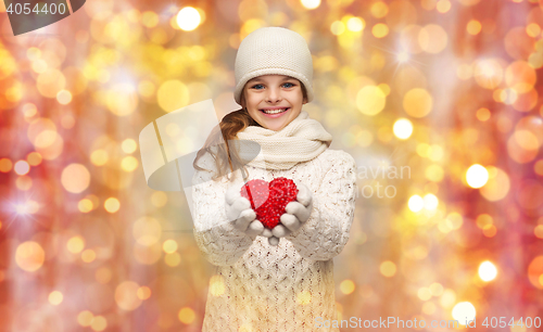 Image of girl in winter clothes with small red heart