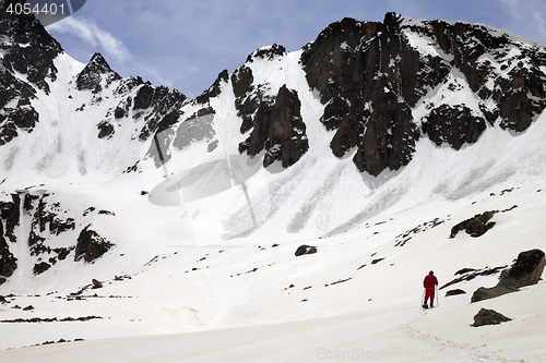 Image of Hiker in snow mountain with trace from avalanches at sun spring 