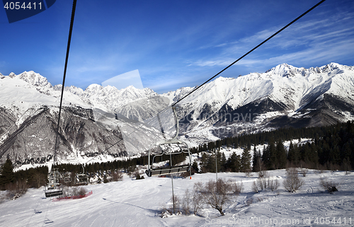 Image of Chair-lift and ski slope in snow winter mountains at nice sun da