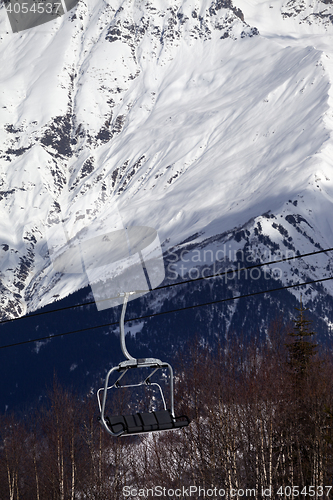 Image of Ski lift in snow mountains at sun winter day