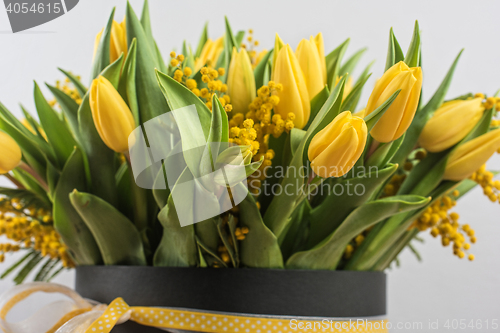 Image of Bright spring bouquet of tulips and mimosa flowers