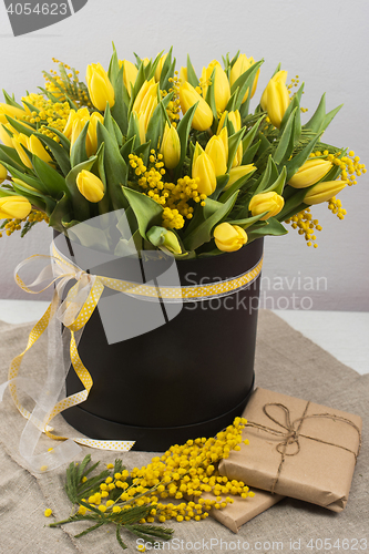 Image of Bright spring bouquet of tulips and mimosa flowers