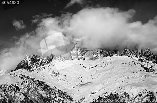 Image of Black and white snow mountains in fog at sun winter day