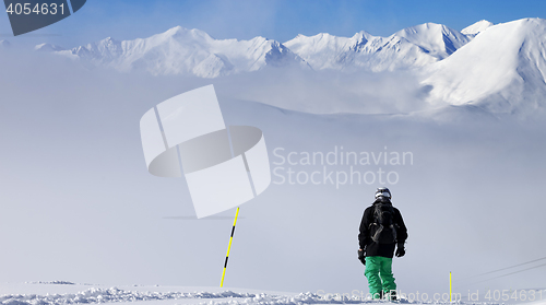 Image of Panoramic view on snowboarder on snowy slope with new fallen sno