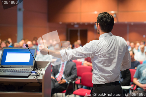 Image of Public speaker giving talk at Business Event.