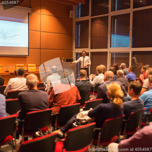 Image of Business speaker giving a talk in conference hall.