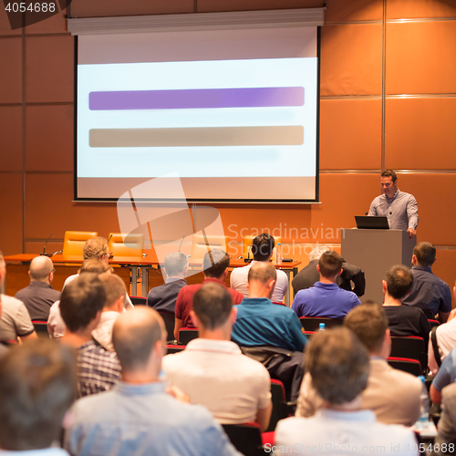 Image of Business speaker giving a talk in conference hall.