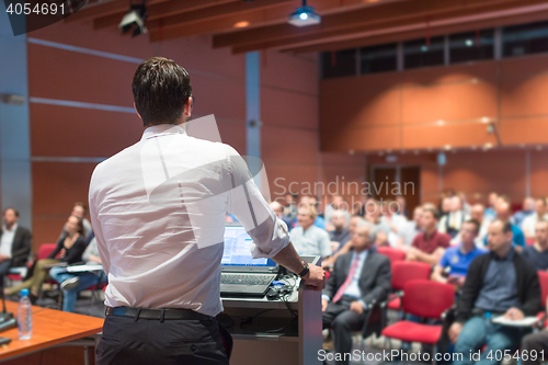 Image of Public speaker giving talk at Business Event.