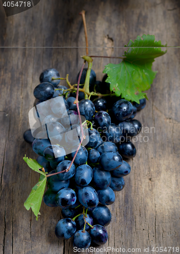 Image of Bunch of red grapes on wooden background