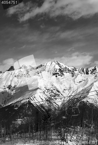 Image of Black and white ski lift in snow mountains at nice winter day