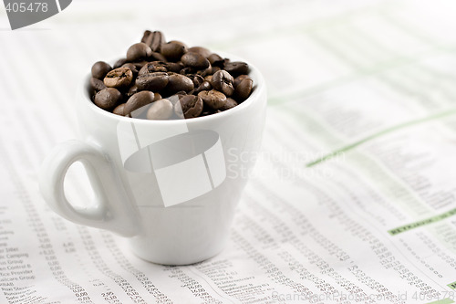 Image of Classic espresso cup on financial pages, shallow depth of field