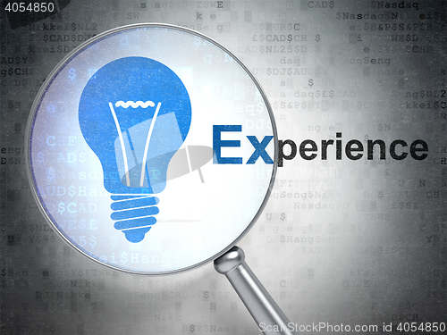 Image of Finance concept: Light Bulb and Experience with optical glass