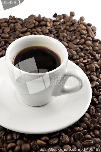 Image of Classic white espresso cup on coffee beans