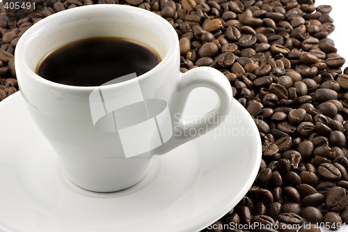 Image of Classic white espresso cup on coffee beans