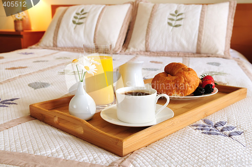 Image of Breakfast on a bed in a hotel room