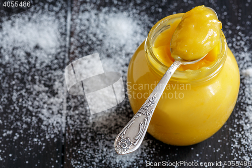 Image of Lemon custard in a teaspoon and glass jar.