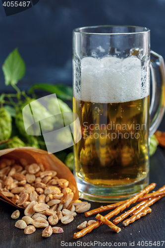 Image of Salted sticks, peanuts and mug of beer.