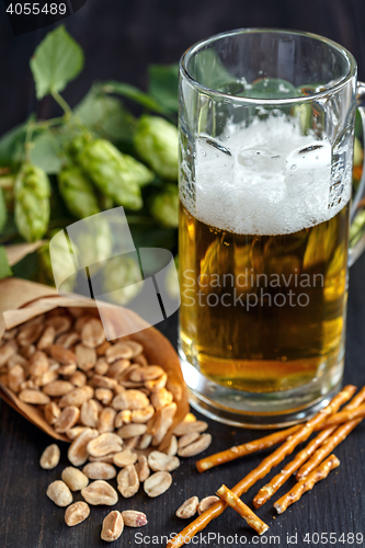 Image of Bag of peanuts and mug of beer.