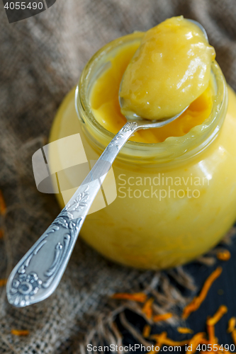 Image of Jar with lemon custard and a teaspoon.