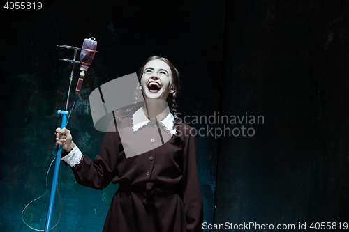 Image of Portrait of a young girl in school uniform as a vampire woman