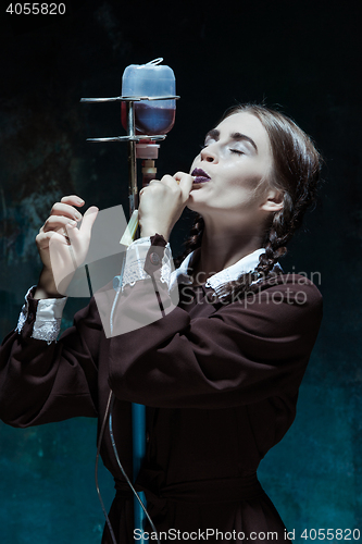 Image of Portrait of a young girl in school uniform as a vampire woman