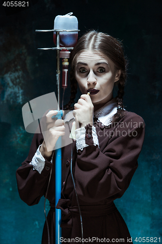 Image of Portrait of a young girl in school uniform as a vampire woman