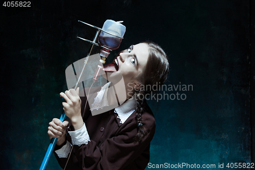 Image of Portrait of a young girl in school uniform as a vampire woman
