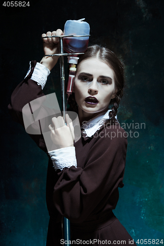 Image of Portrait of a young girl in school uniform as a vampire woman