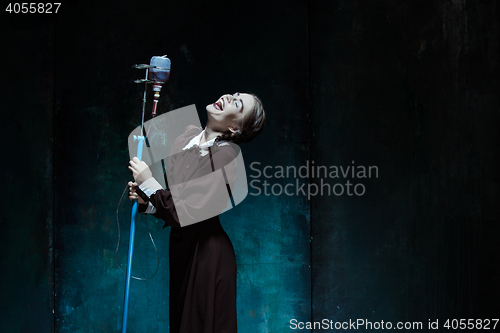 Image of Portrait of a young girl in school uniform as a vampire woman