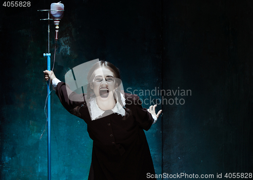 Image of Portrait of a young girl in school uniform as a vampire woman