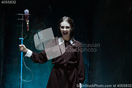 Image of Portrait of a young girl in school uniform as a vampire woman