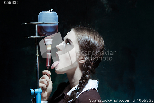 Image of Portrait of a young girl in school uniform as a vampire woman