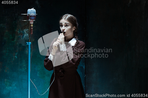 Image of Portrait of a young girl in school uniform as a vampire woman