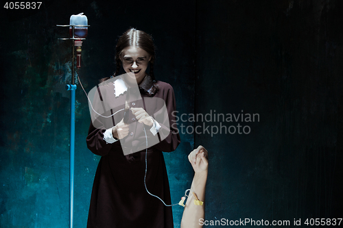 Image of Portrait of a young girl in school uniform as killer woman