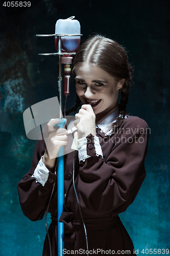 Image of Portrait of a young girl in school uniform as a vampire woman