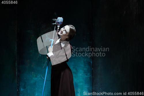 Image of Portrait of a young girl in school uniform as a vampire woman