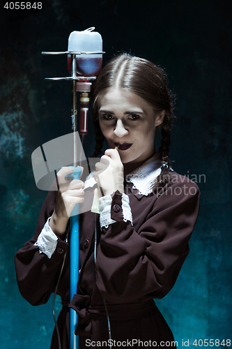 Image of Portrait of a young girl in school uniform as a vampire woman
