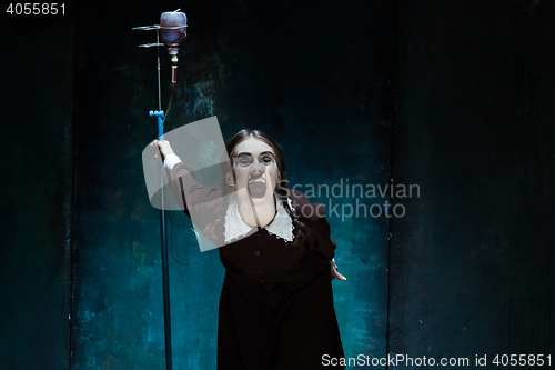 Image of Portrait of a young girl in school uniform as a vampire woman