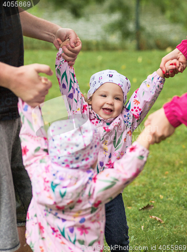 Image of The two little baby girls playing in autumn park