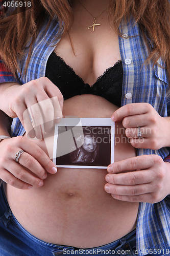 Image of pregnancy woman with ultrasound photo