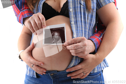 Image of pregnancy woman with ultrasound photo