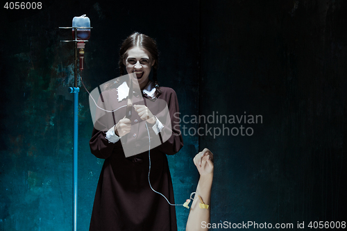 Image of Portrait of a young girl in school uniform as killer woman