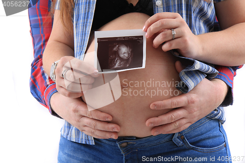 Image of pregnancy woman with ultrasound photo