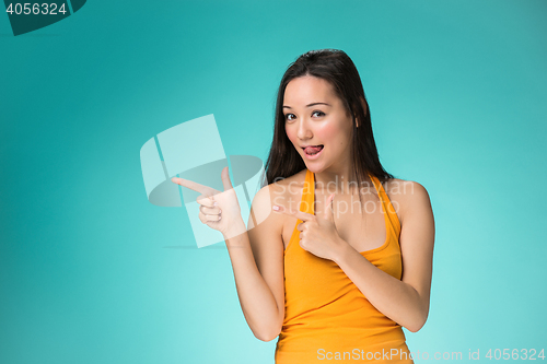 Image of The happy Chinese girl on yellow background