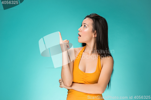 Image of The happy Chinese girl on yellow background