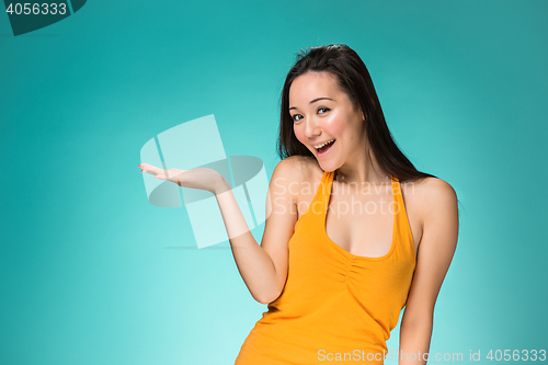 Image of The happy Chinese girl on yellow background