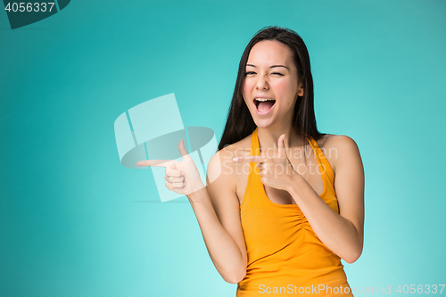 Image of The happy Chinese girl on yellow background