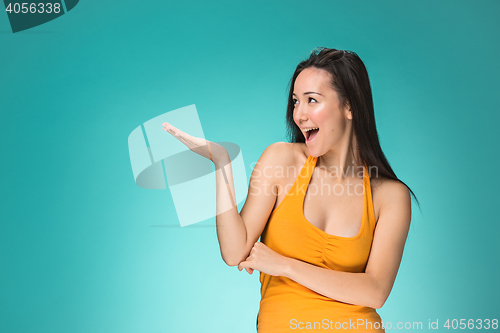 Image of The happy Chinese girl on yellow background
