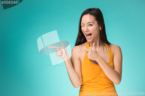 Image of The happy Chinese girl on yellow background